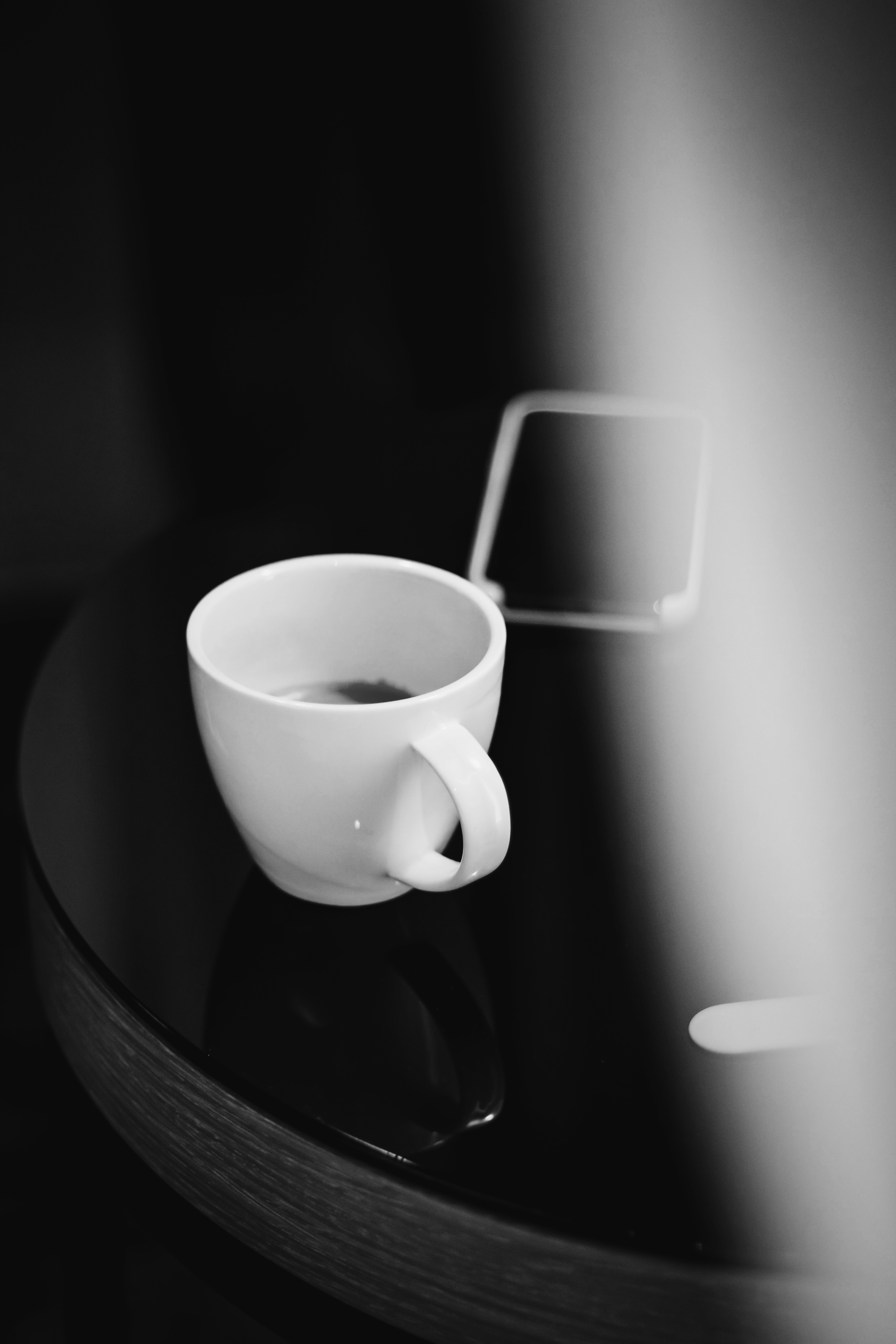 white ceramic mug on black table