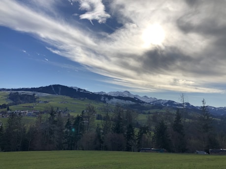 A serene landscape featuring rolling hills under a dramatic sky, capturing the essence of nature's beauty.