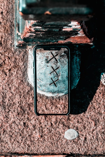 A rugged, durable phone case with reinforced corners on a concrete surface.