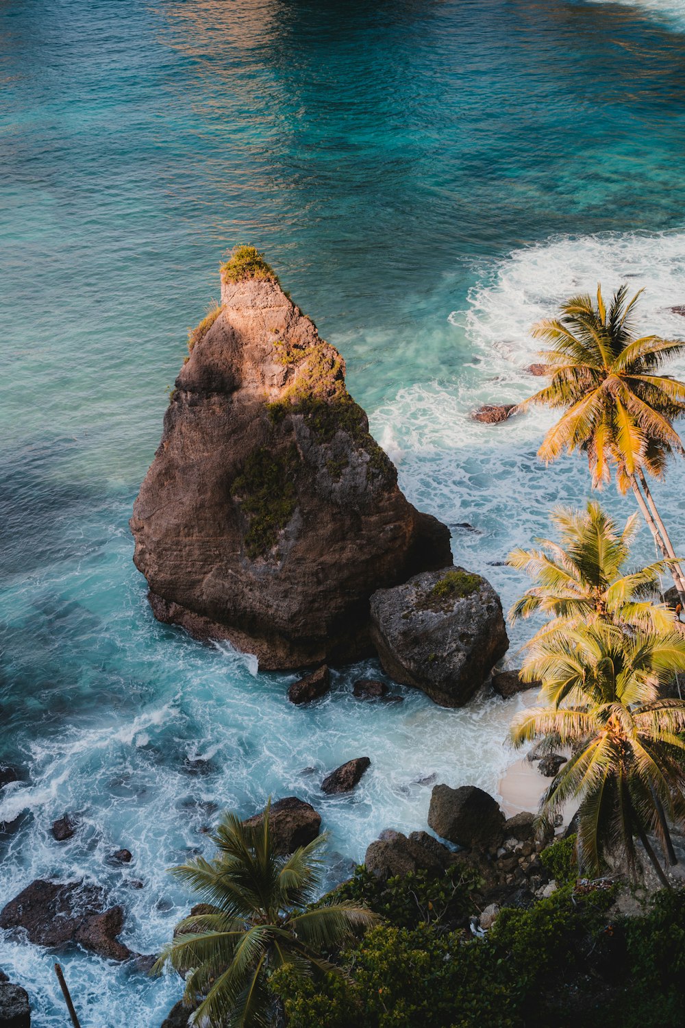 brown rock formation on sea during daytime