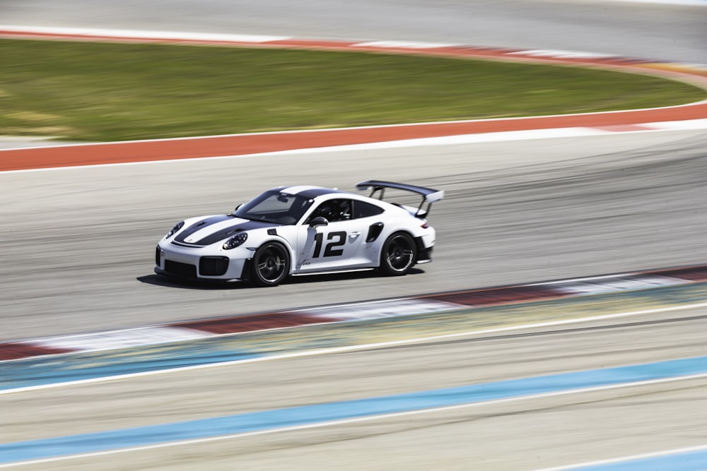 white and black porsche 911 on road during daytime