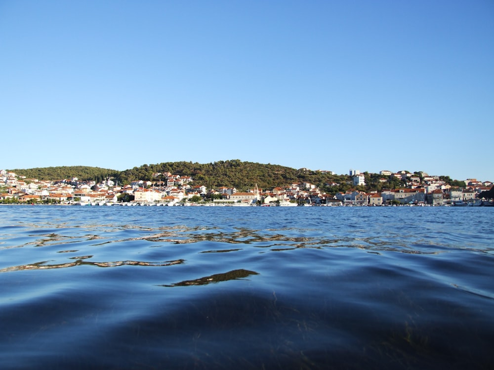 body of water near city buildings during daytime