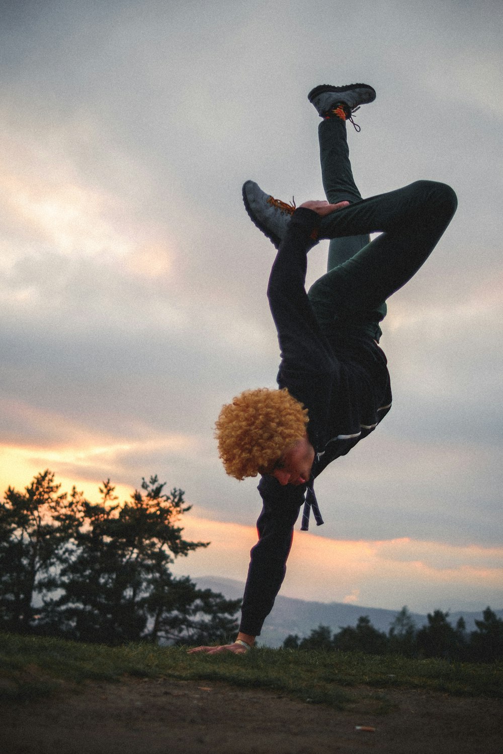 woman in black jacket and black pants jumping on air during daytime