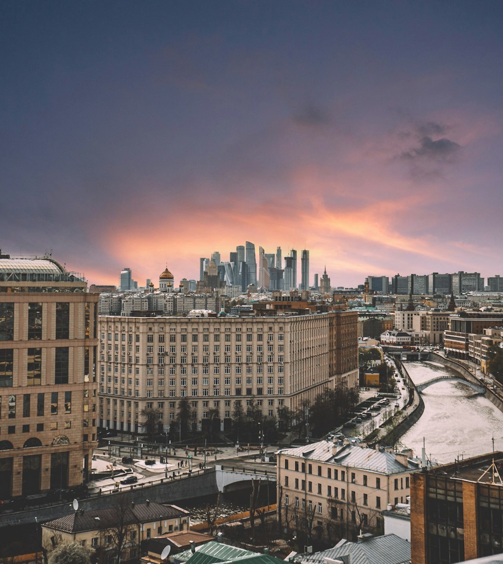 city buildings under blue sky during sunset