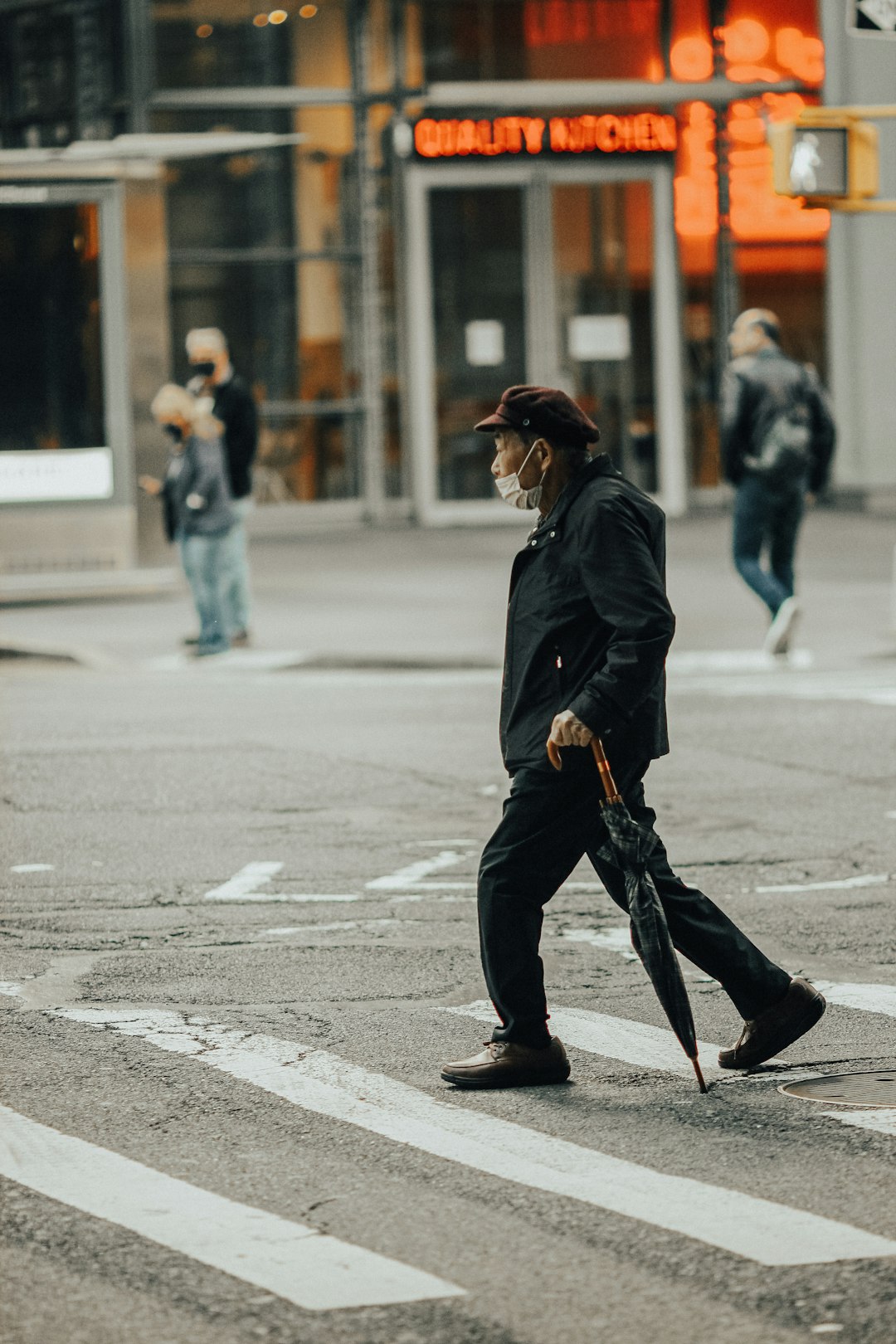 woman in black jacket walking on street during daytime