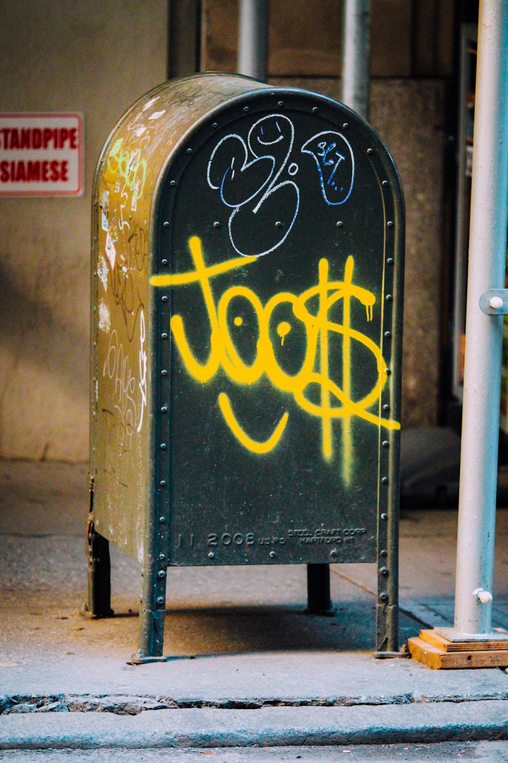 black and yellow metal mail box