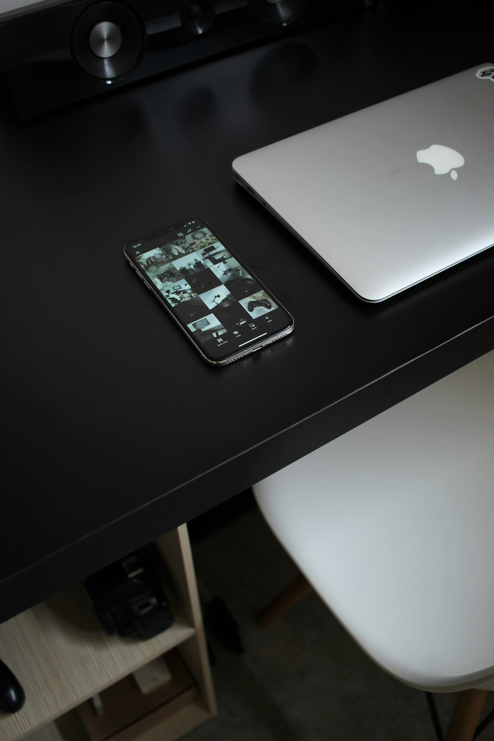 silver macbook on black table