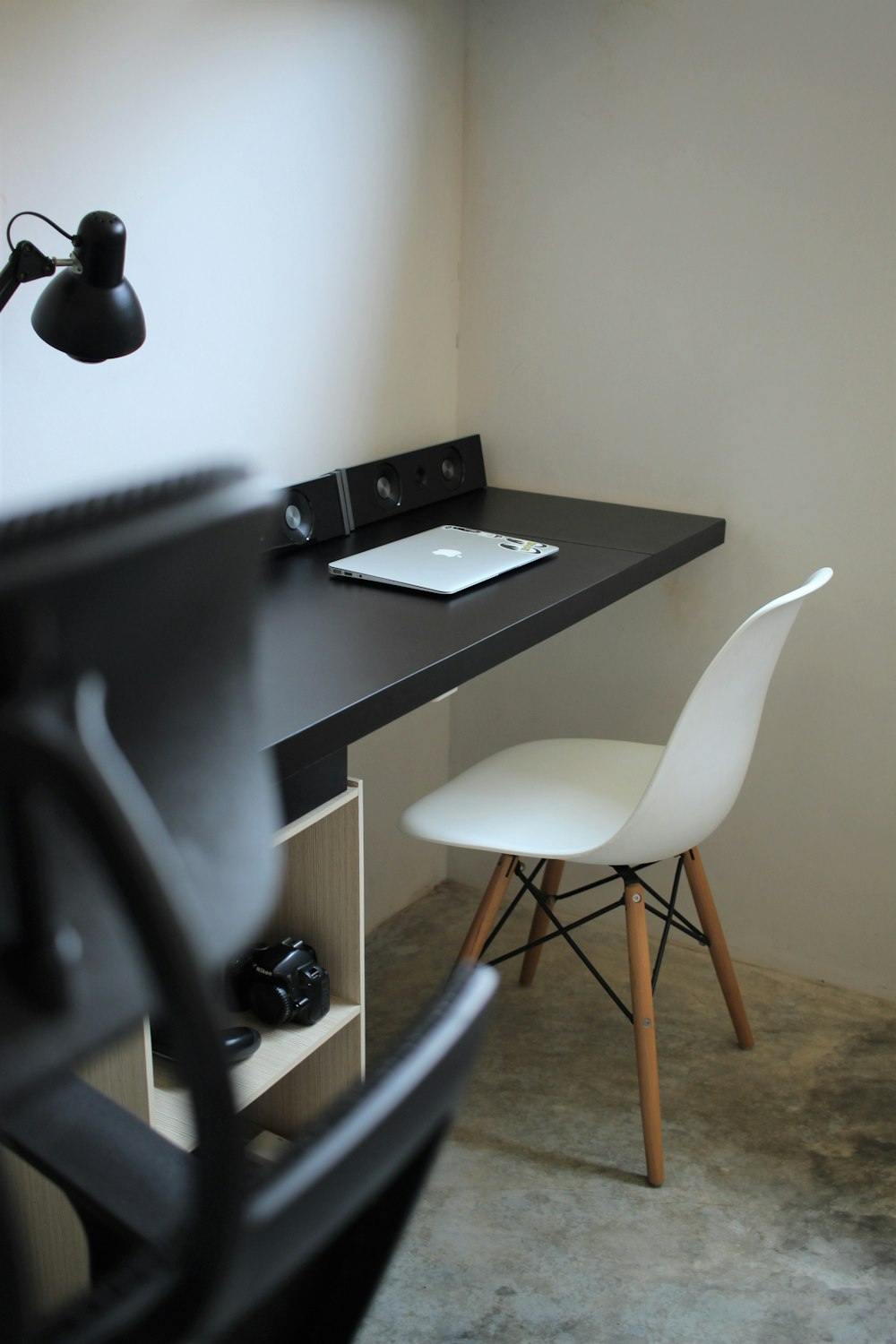 black laptop computer on black wooden table