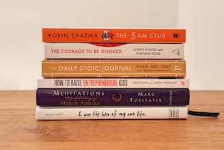 assorted books on brown wooden table