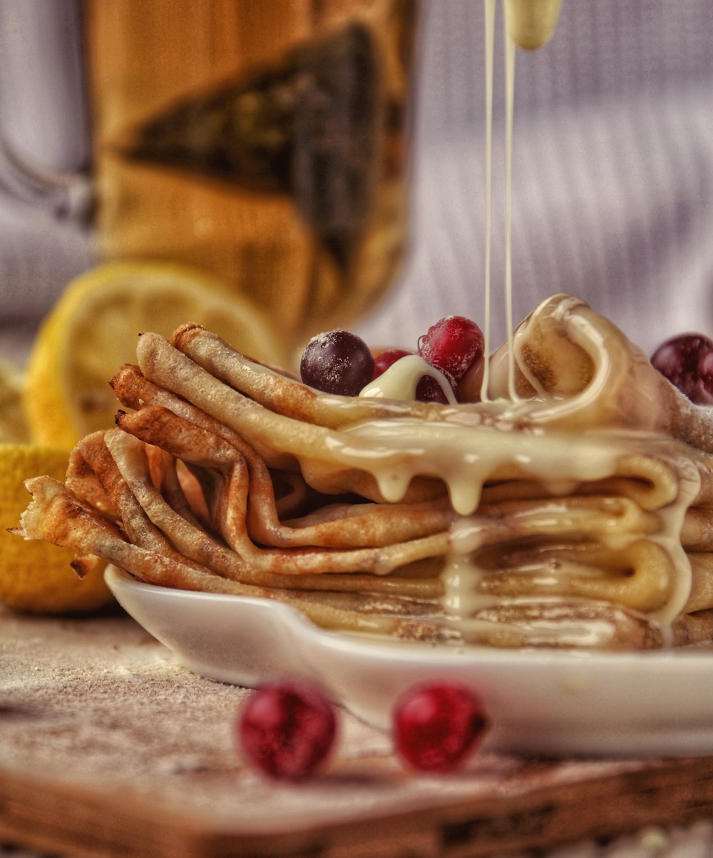 pasta with red berries on white ceramic plate