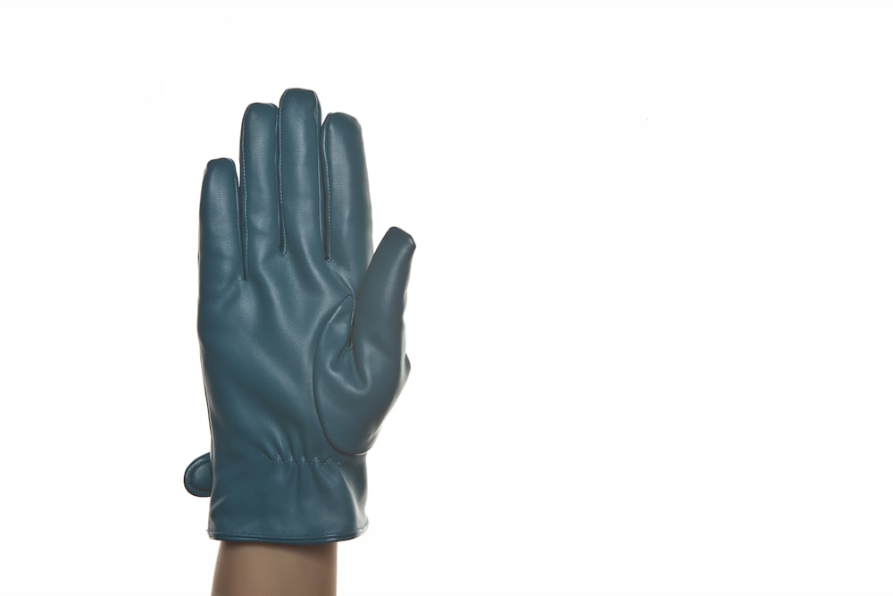 person wearing black gloves on white background