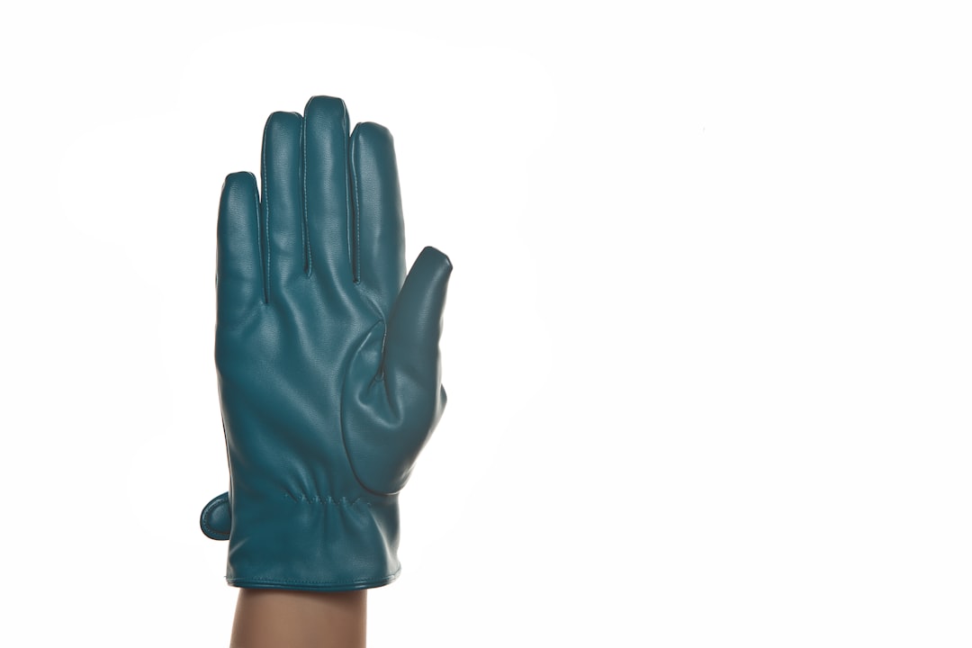 person wearing black gloves on white background