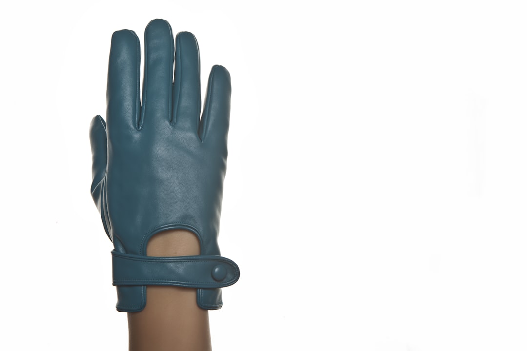 person wearing black leather gloves, Blue glove