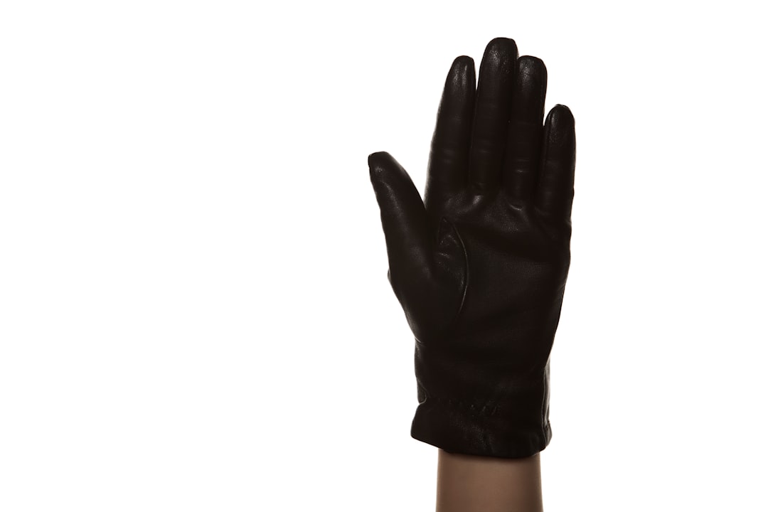 person in black gloves with white background