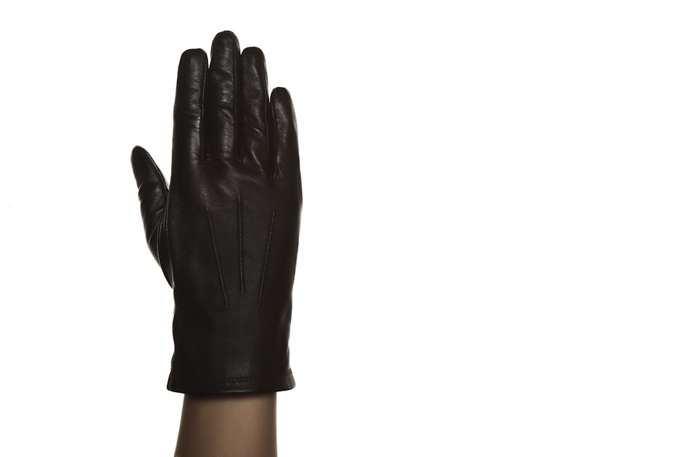 person wearing black leather gloves