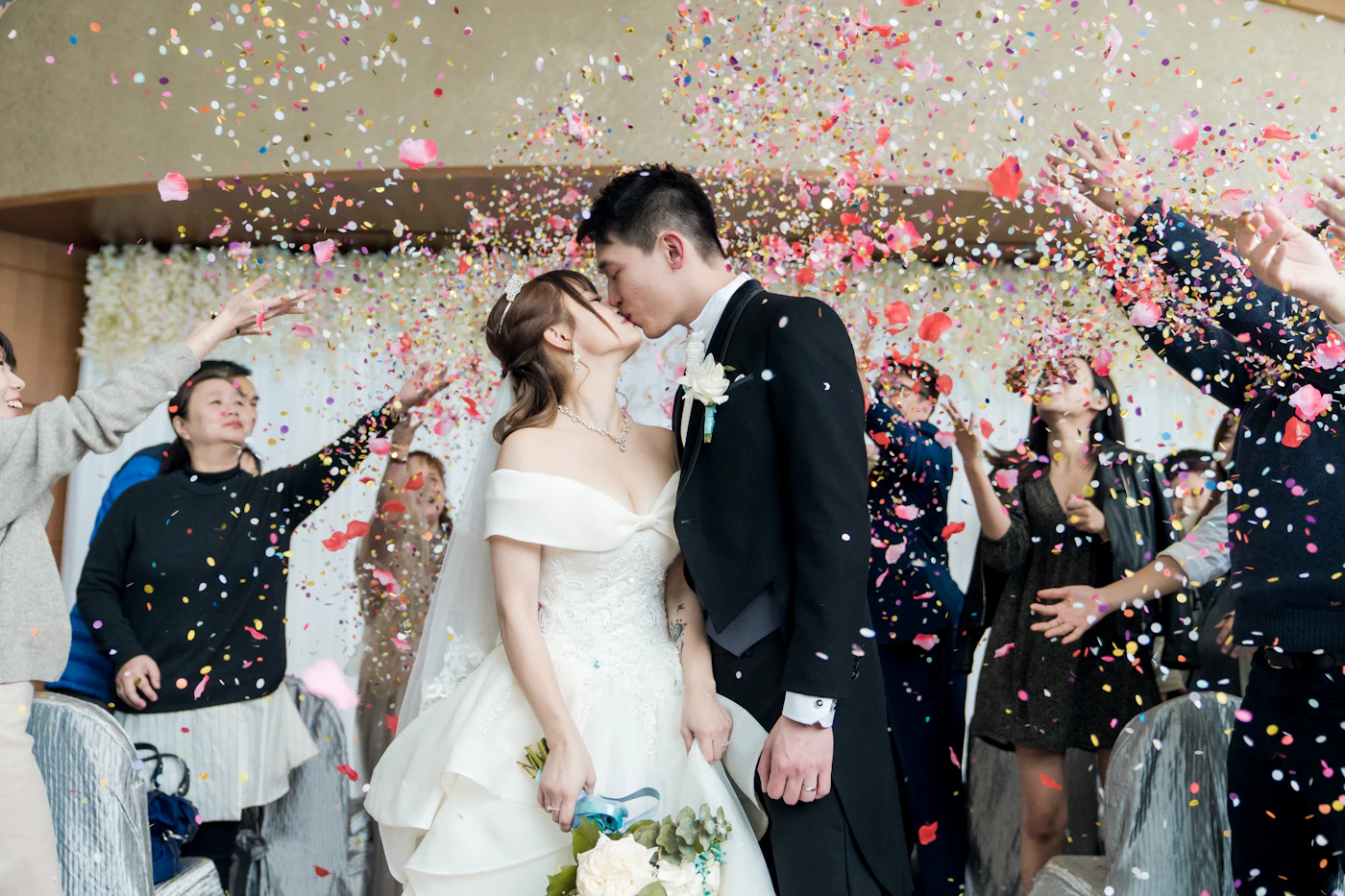 Splitting wedding costs with both families — A family raising glasses at a wedding reception, symbolizing shared celebration and contribution.