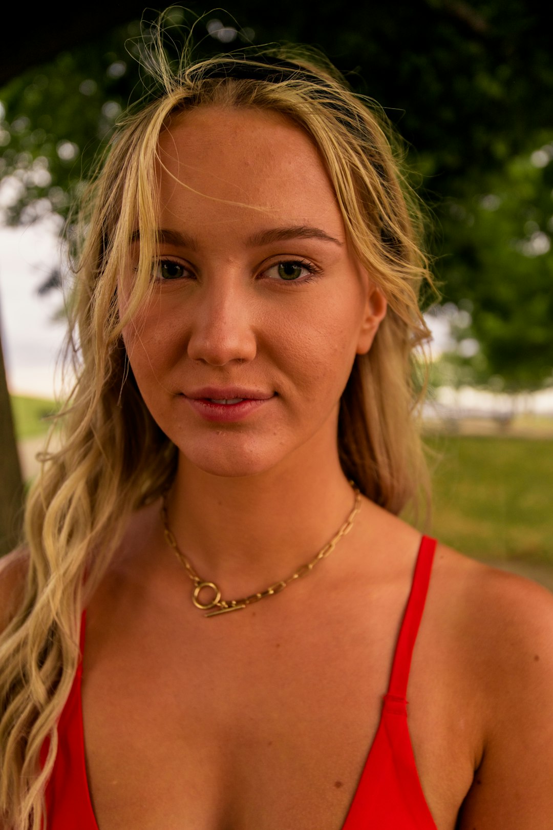 woman in red tank top with silver necklace