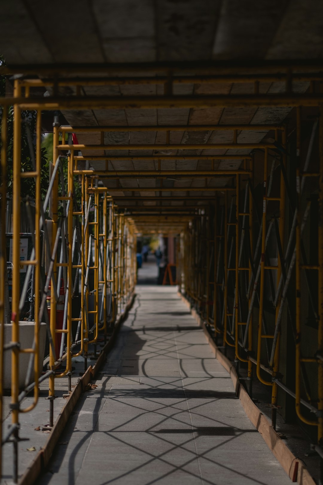 brown wooden hallway with yellow metal railings
