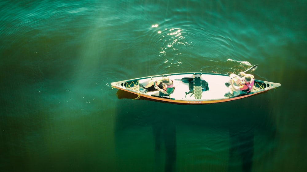 white and brown boat on body of water during daytime