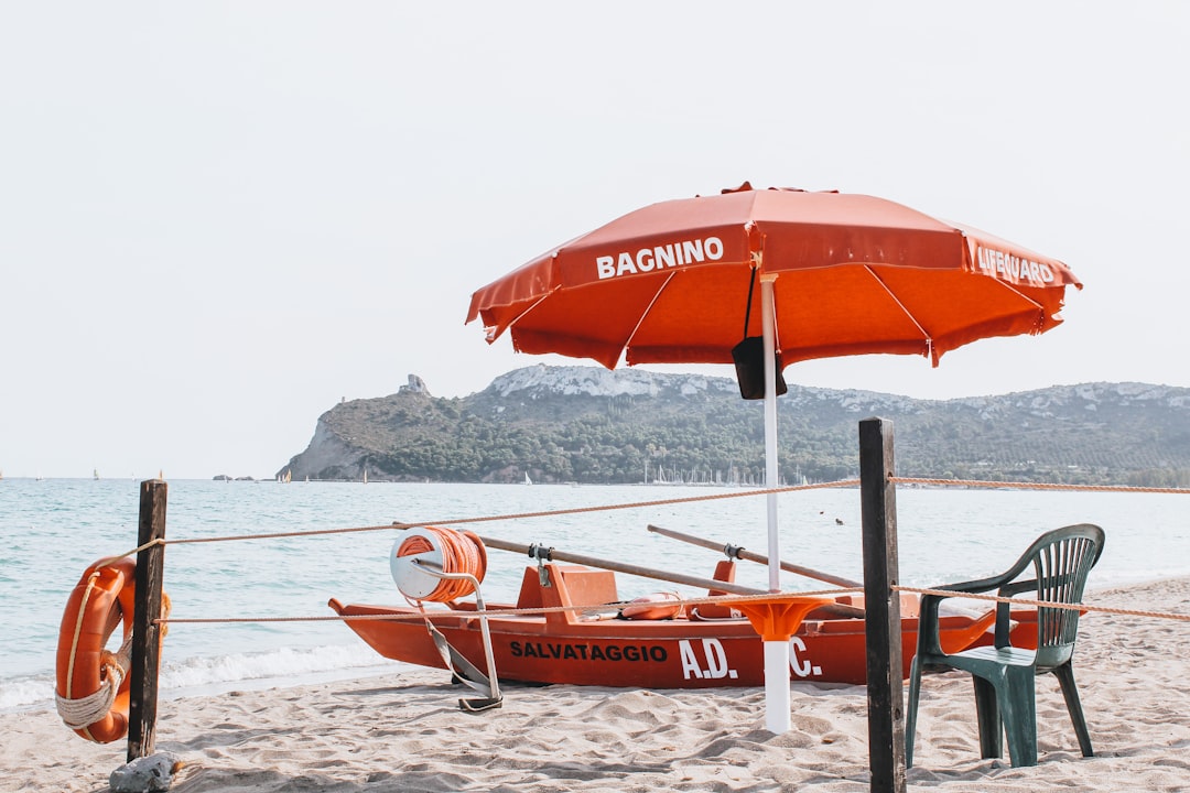 orange and white boat on beach during daytime