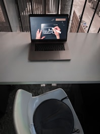 Student working on AutoCAD electrical design on a laptop at home.