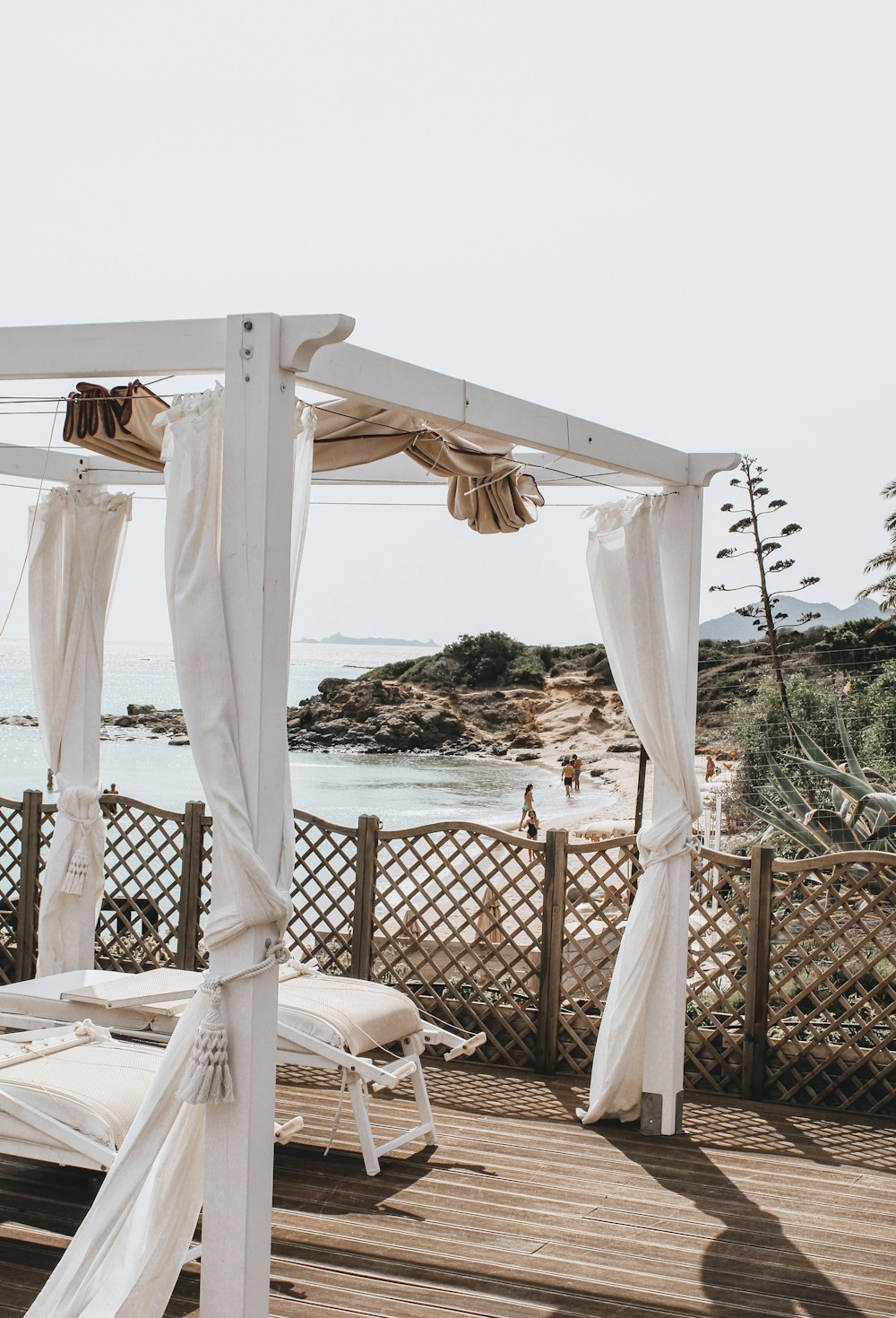 white patio umbrella near body of water during daytime