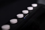 Close-up of a sleek electronic device with illuminated buttons.