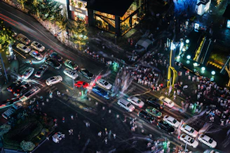 An energetic snapshot of a bustling city intersection at night.