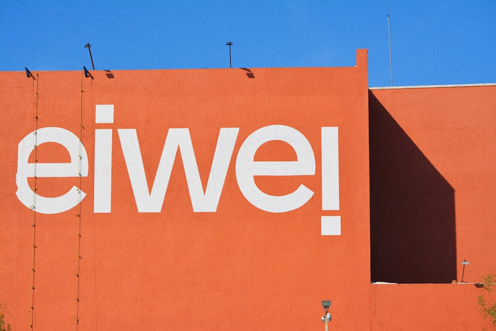 a red building with the word ewel painted on it