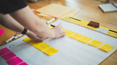 person writing on white paper