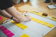 Colorful bookmarks and notes scattered on a wooden table.
