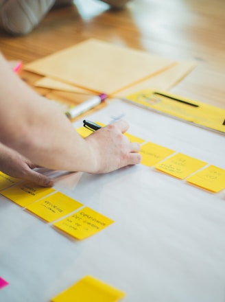 person writing on white paper