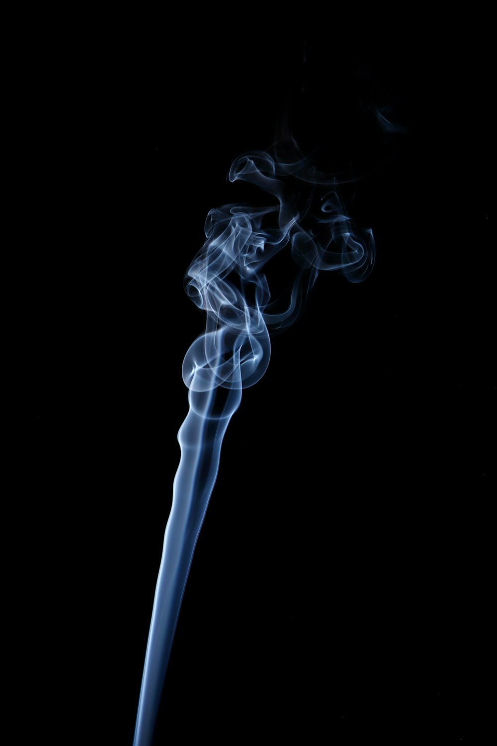 a long blue smoke stick on a black background