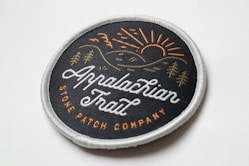 a black and brown round woven patch