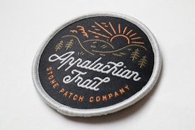 a black and brown round woven patch