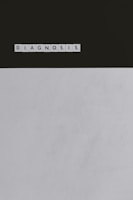 A series of Scrabble tiles spelling out the word 'DIAGNOSIS' is arranged horizontally on a surface. The background is divided, with a dark upper section and a light lower section.