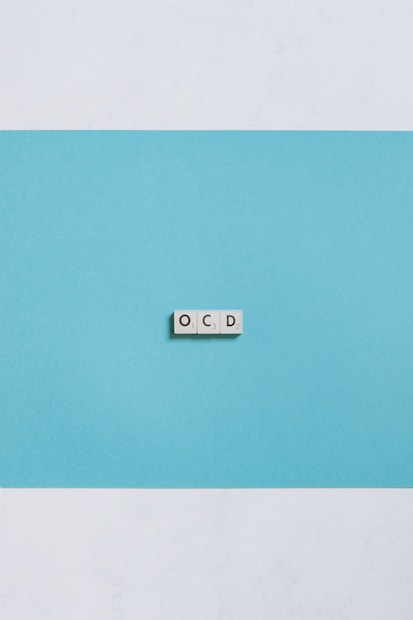 white wall mounted switch on blue wall indicating OCD obessesive compulsive disorder