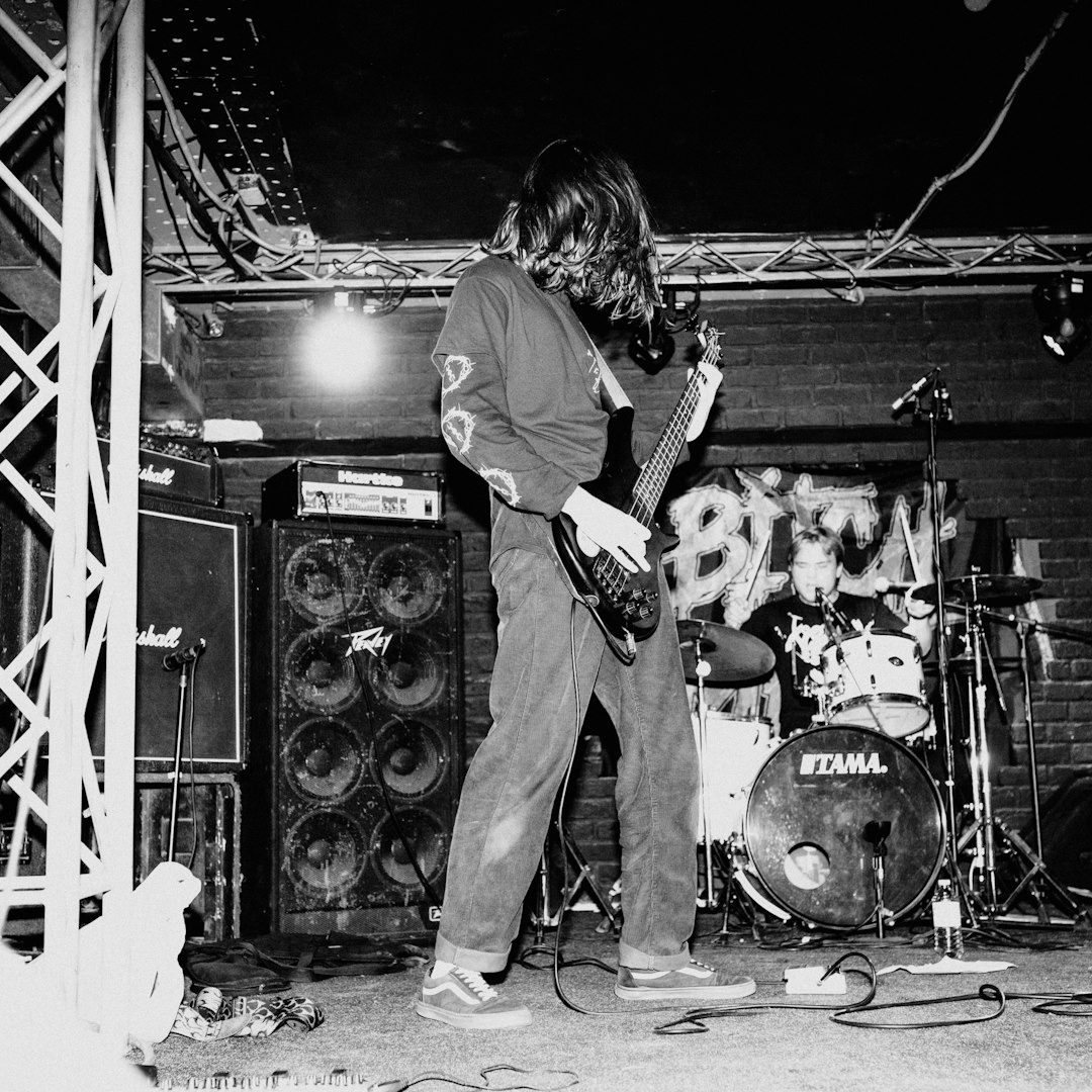 man playing guitar on stage