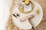 gold and silver hair dryer on white round table