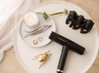 black hair dryer on white round ceramic plate