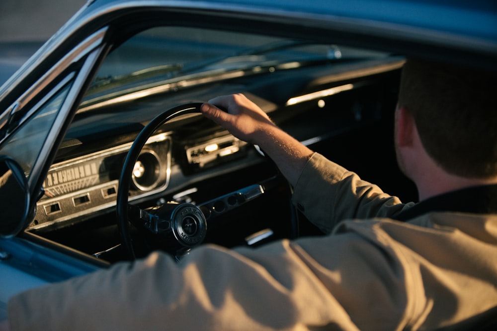 person in brown pants driving car