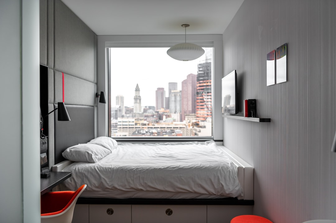 white bed linen on bed, Boston hotel interior design skyline view