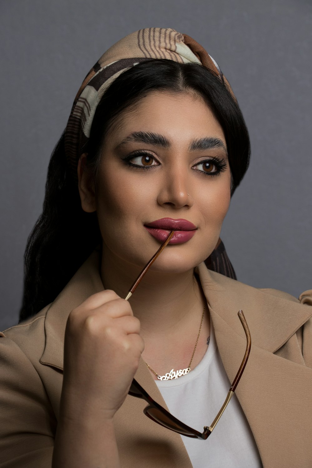 woman in brown blazer with red lipstick