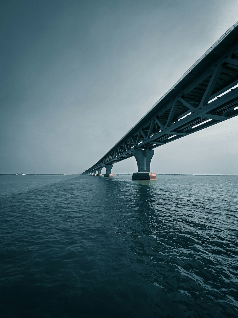 gray metal bridge over the sea