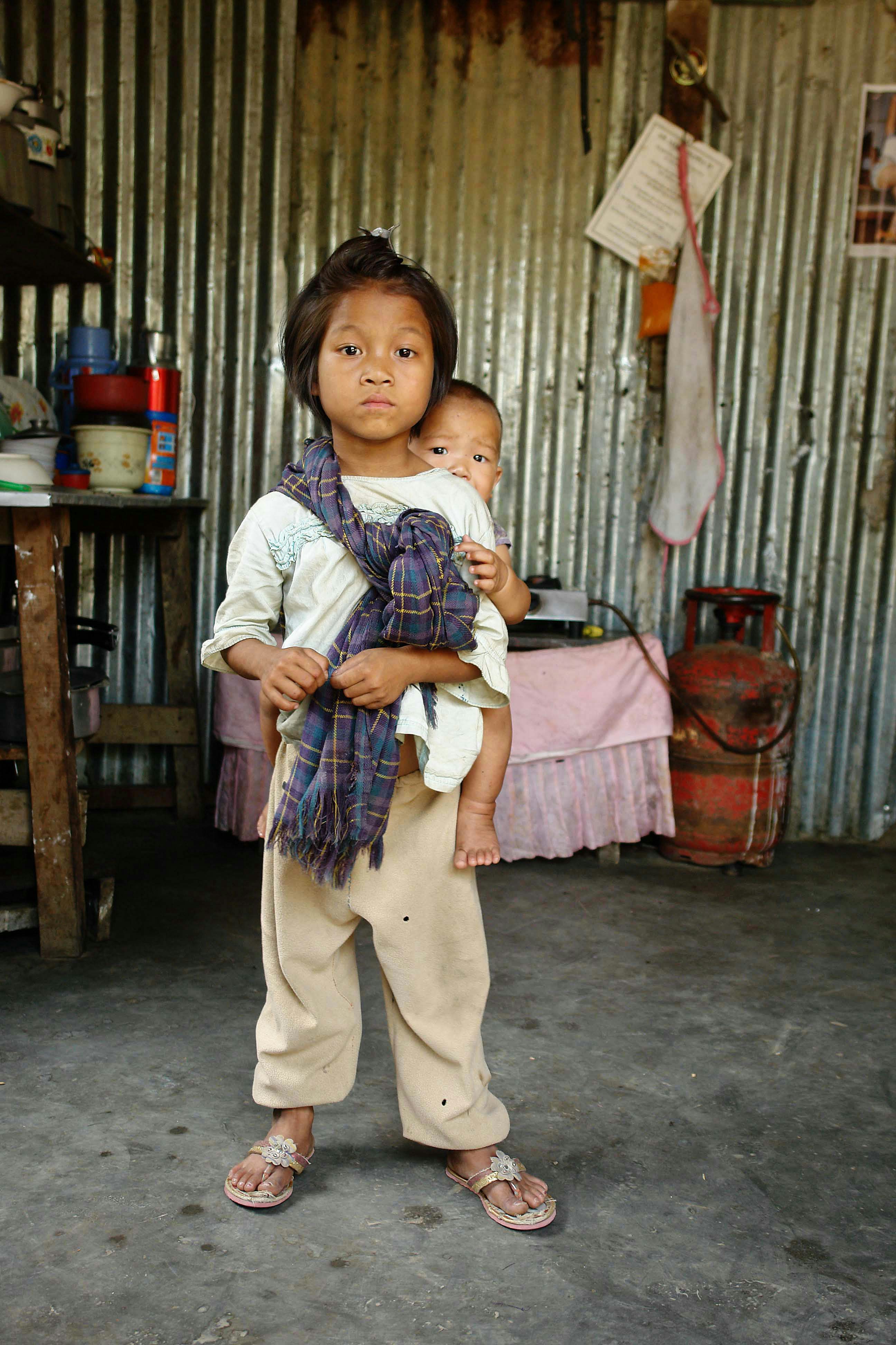 This little girl was protecting her little brother from the the camera man.