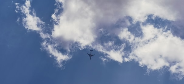 An airplane taking off against a clear blue sky.
