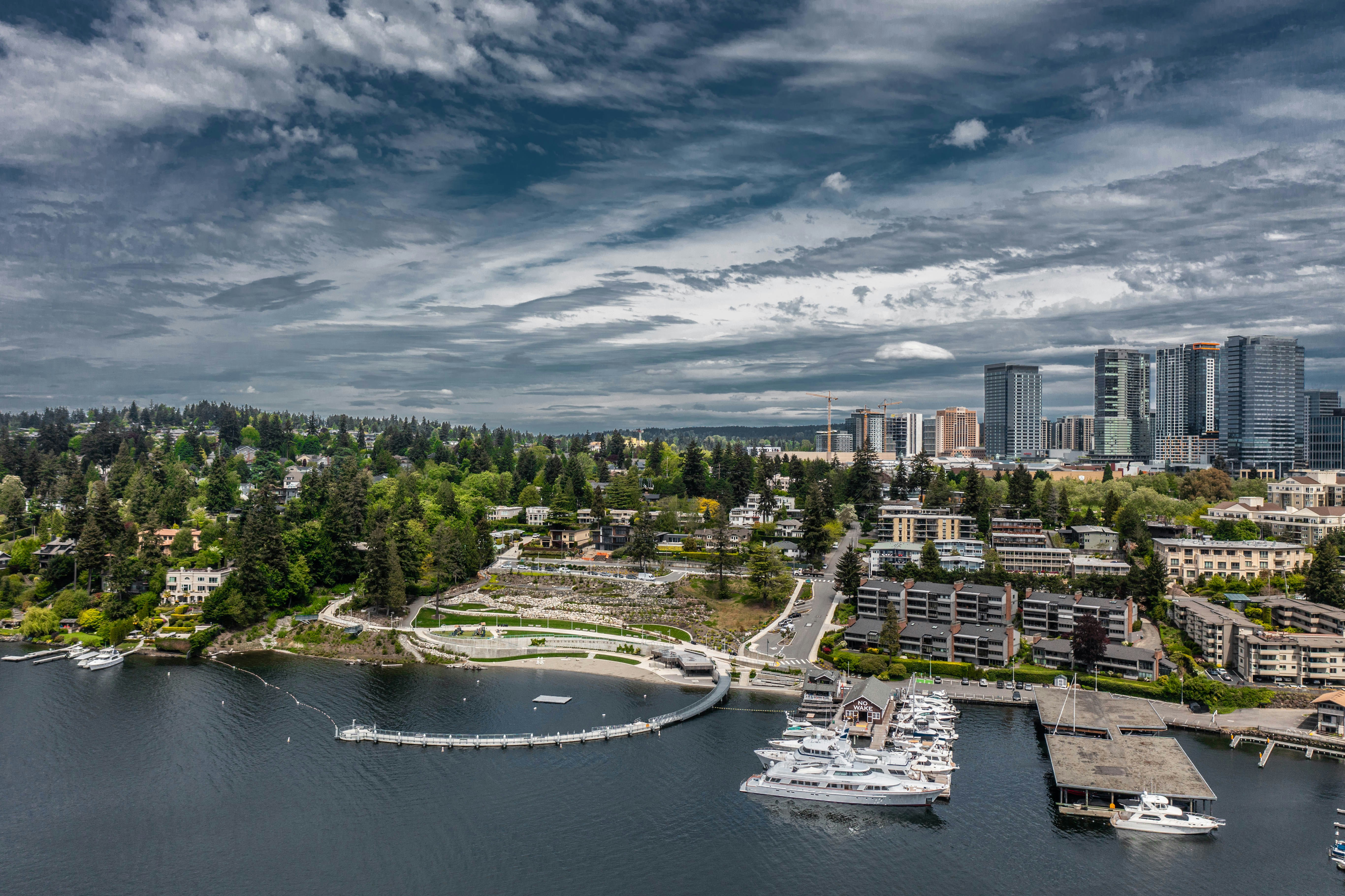 white and brown concrete building near body of water under cloudy sky during daytime