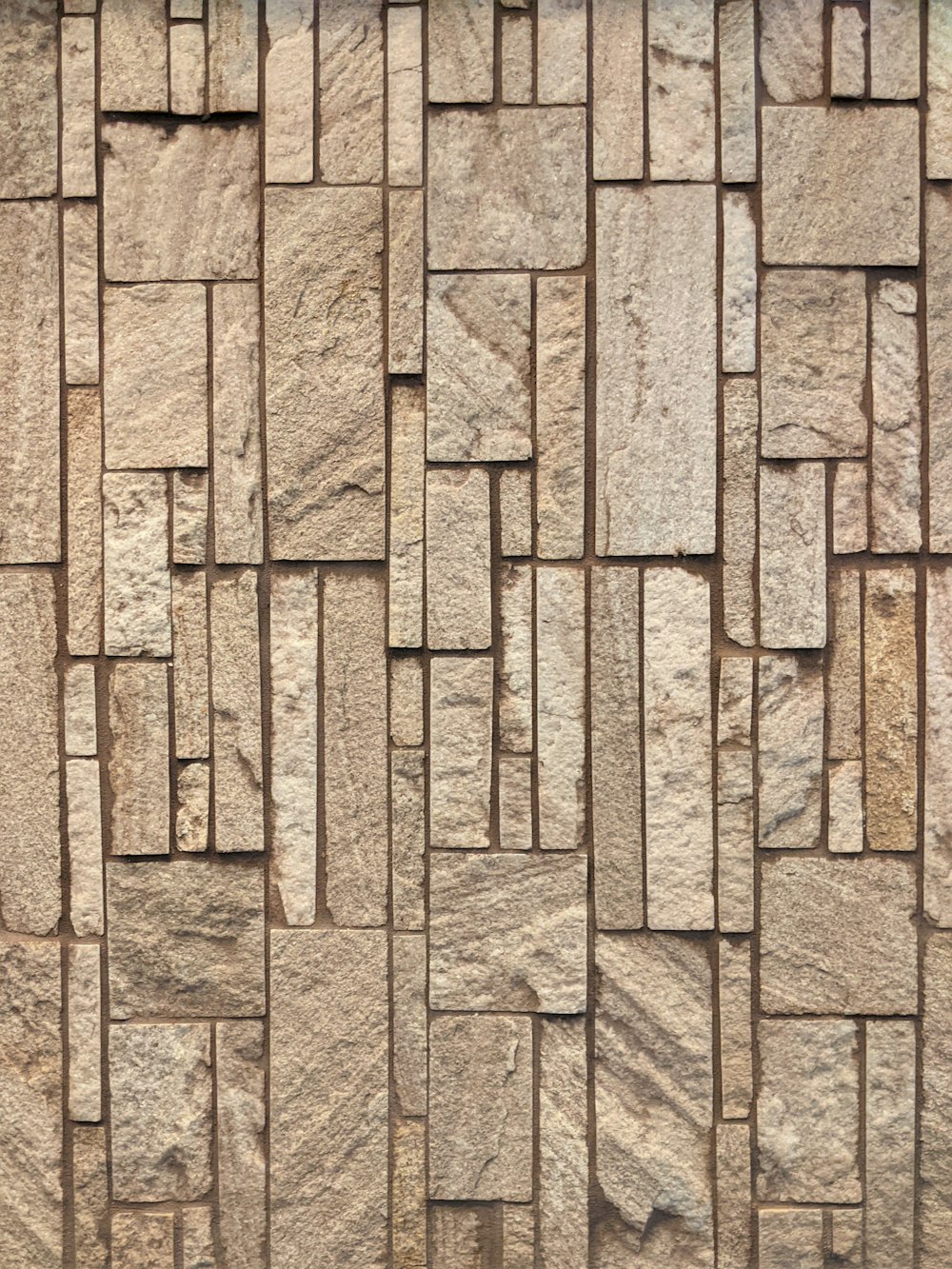 brown brick wall with black and white cross