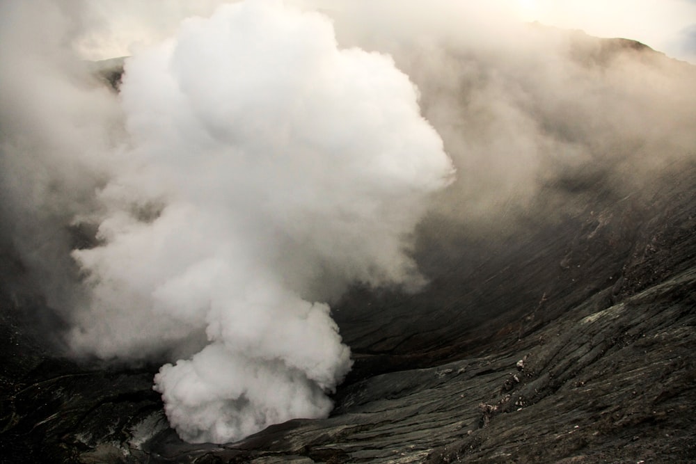 white smoke coming out from mountain