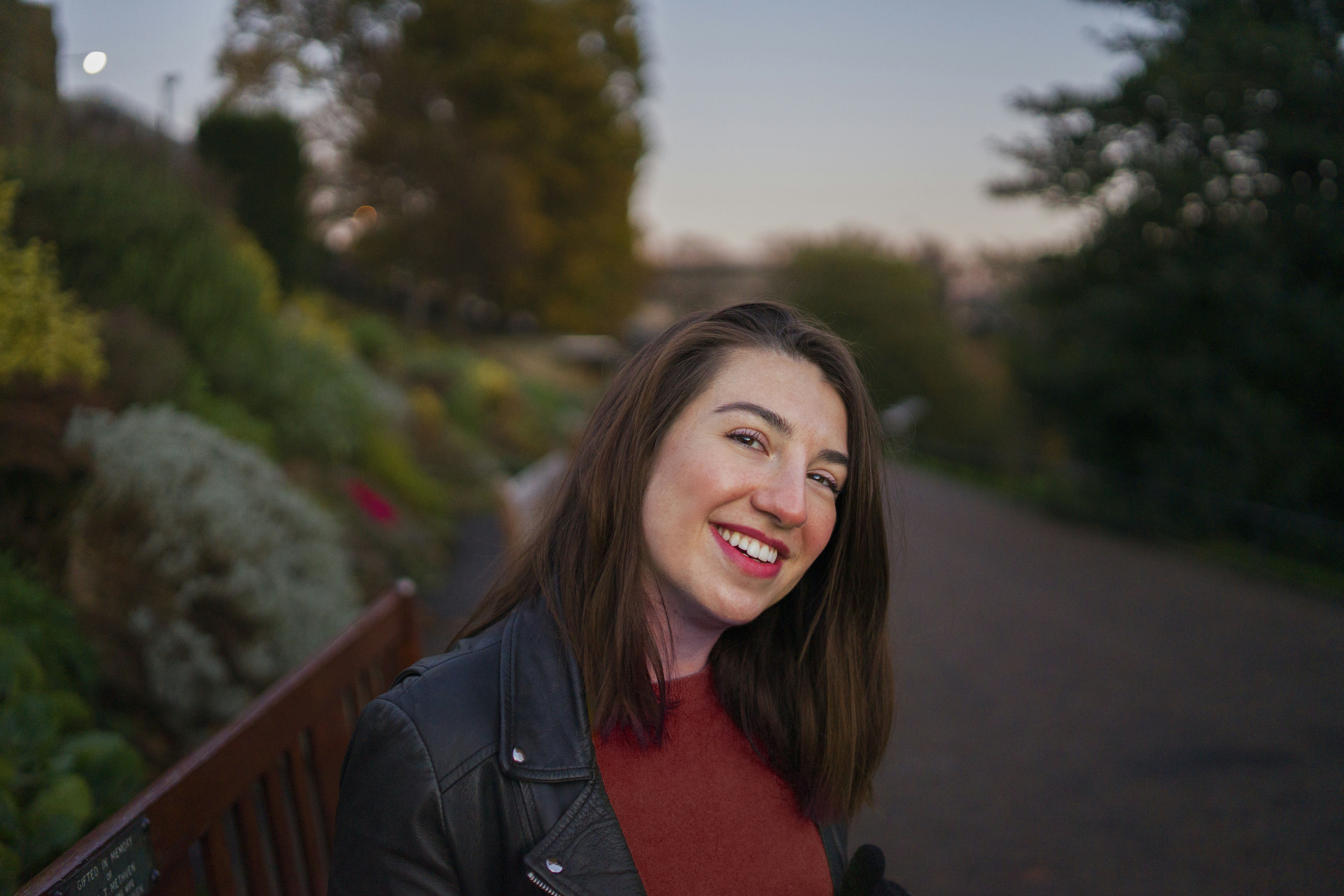 woman in black jacket smiling, Girl sitting on a bench at Princes Street Gardens, Edinburgh.</p><p>November 2020